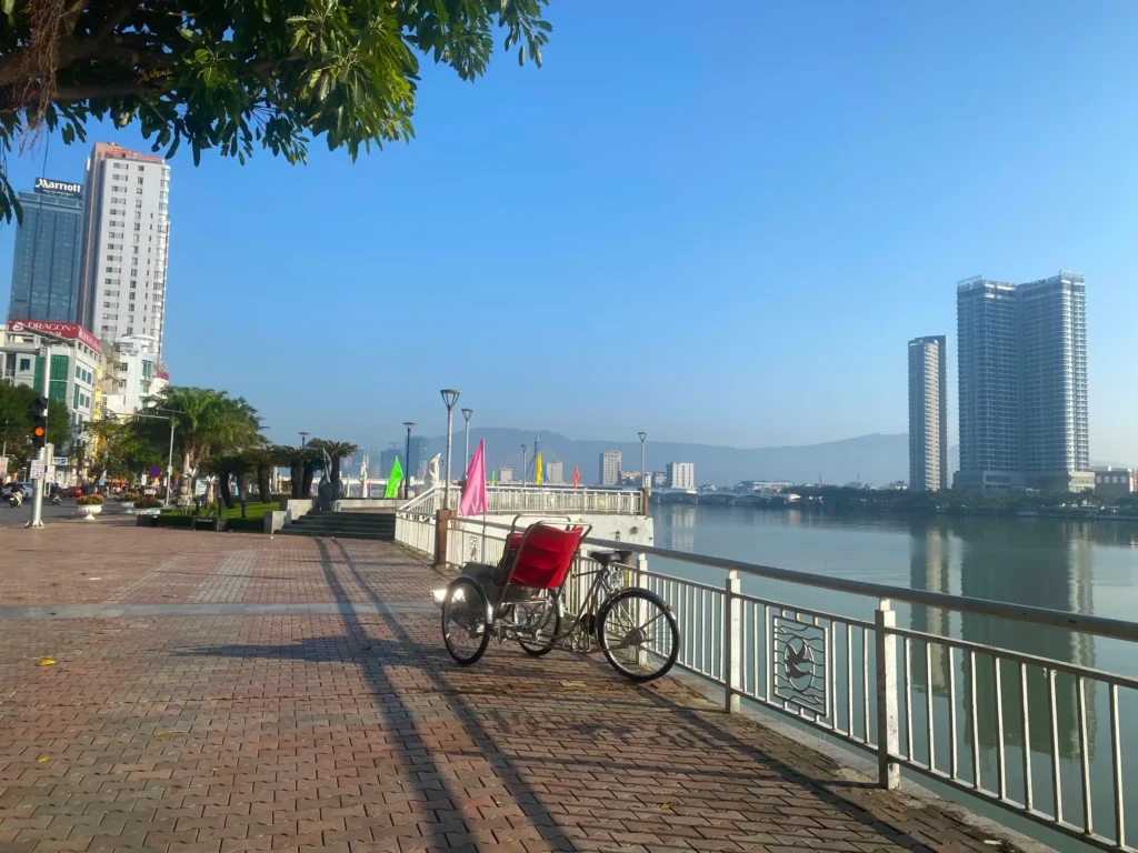 Wondering where to stay in Da Nang; look at this view of the Danang city skyline, mountains and the Han River waterfront in the morning.