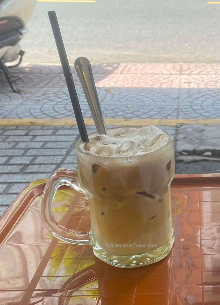 Glass of Vietnamese Milk Coffee, Bac Xiu, which is a popular type of coffee in Ho Chi Minh City, with mainly milk and hint of coffee.