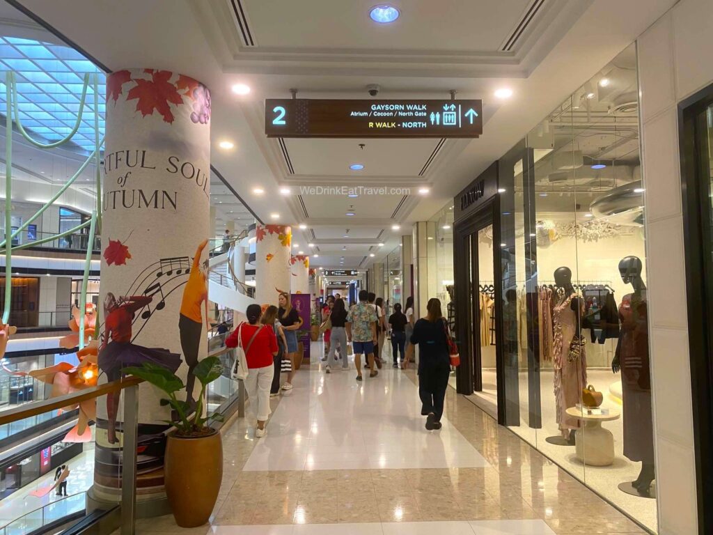 The Gaysorn Village Gaysorn Walk way at R Walk North with people walking past a variety of shops.