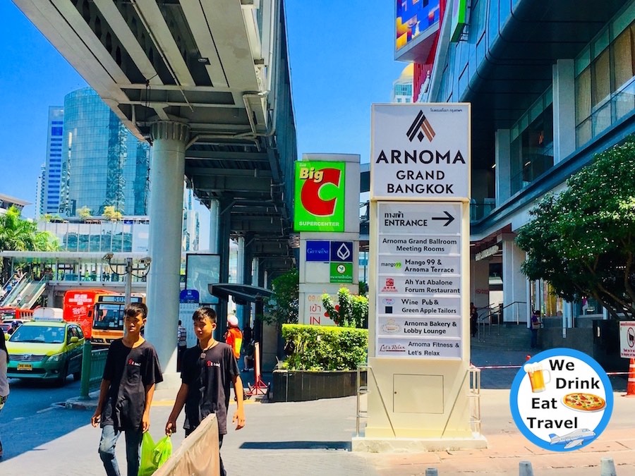 Signs for Arnoma Grand Bangkok Hotel and other shops in the Big C complex in Bangkok, Thailand.