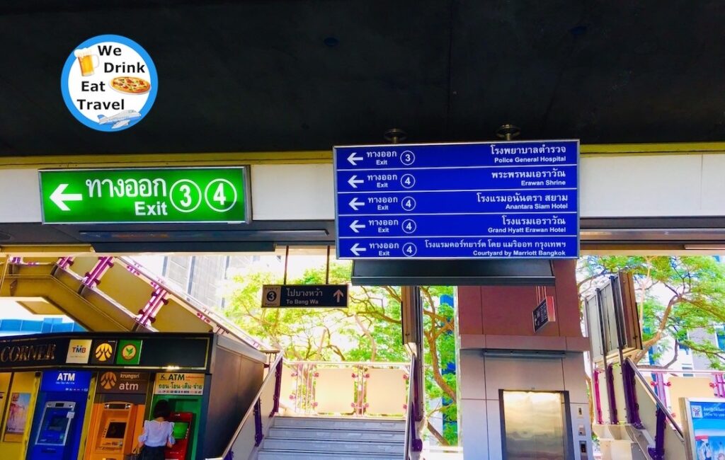 BTS station signs showing Exits 3 and 4 with descriptions and directions for landmark places in Ratchadamri, Bangkok.