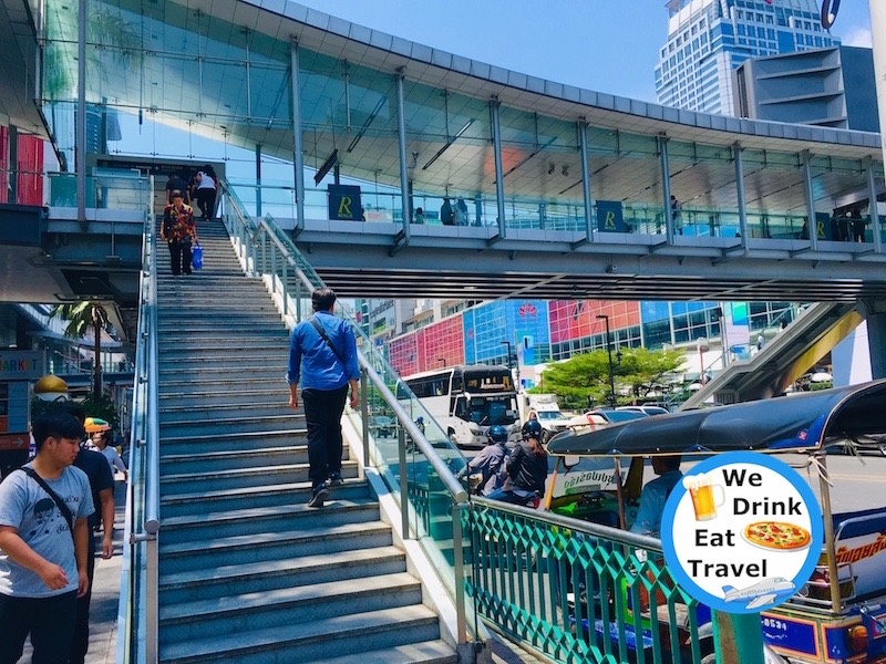 People walking up the stairs and on the Ratchaprasong Skywalk towards Platinum Fashion Mall Bangkok, Thailand.